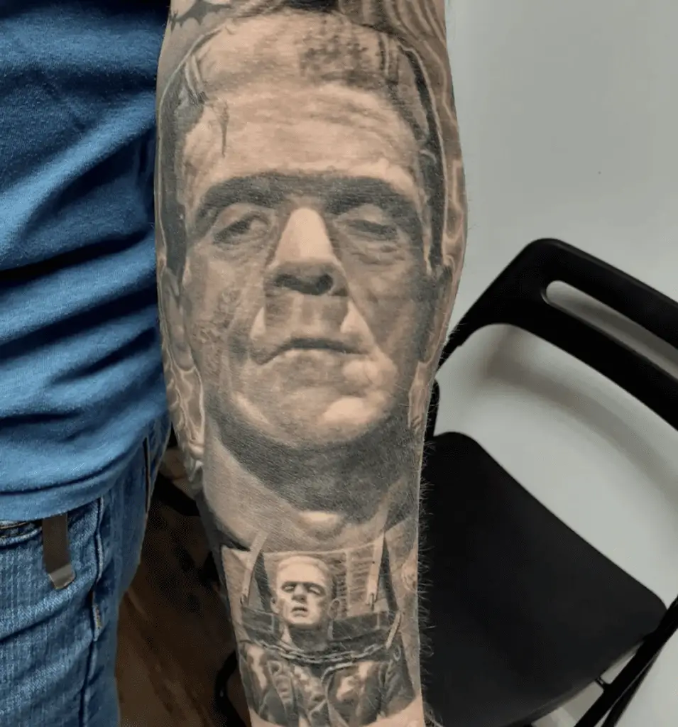 Black and Grey Large Forehead Depressed Man Arm Tattoo