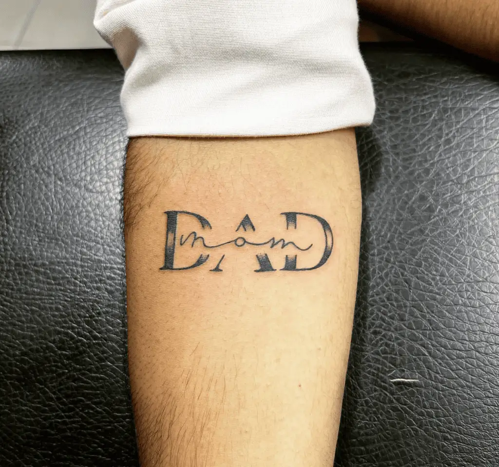Blended Black Ink Mom and Dad Text Arm Tattoo