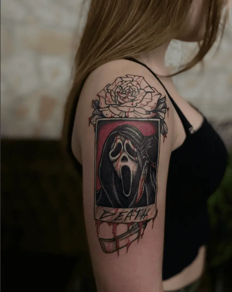 Bloody Photocard Of Grim Reaper With Death Text At The Bottom And A Flower Behind It Arm Tattoo