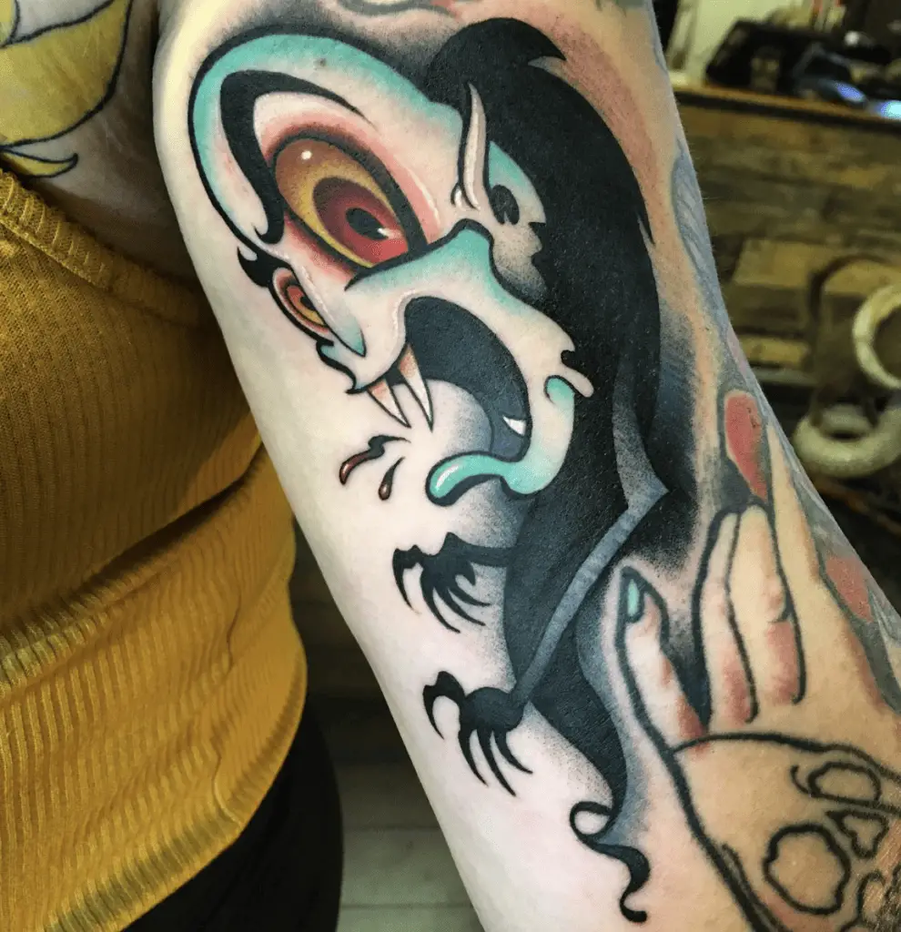 Cartoon Style Hairless Vampire Spirit Mouth Opened Arm Tattoo