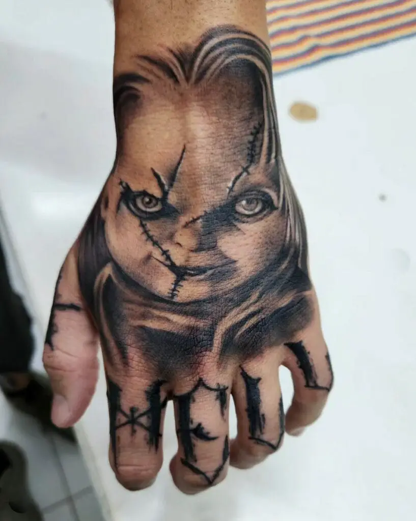 Chucky And Hell Letters On Fingers Hand Tattoo