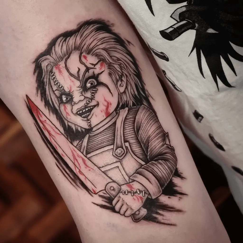 Chucky Holding A Knife Covered by a Blood Arm Tattoo