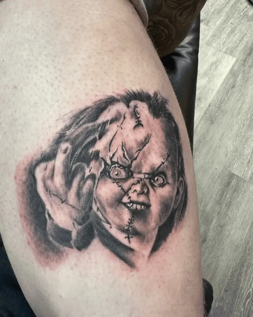Chucky Making a Middle Finger Arm Tattoo