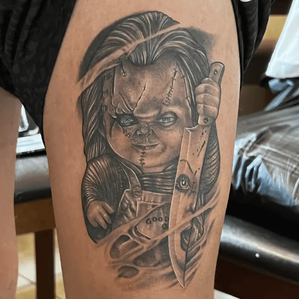 Chucky Threatening A Woman With A Knife Thigh Tattoo