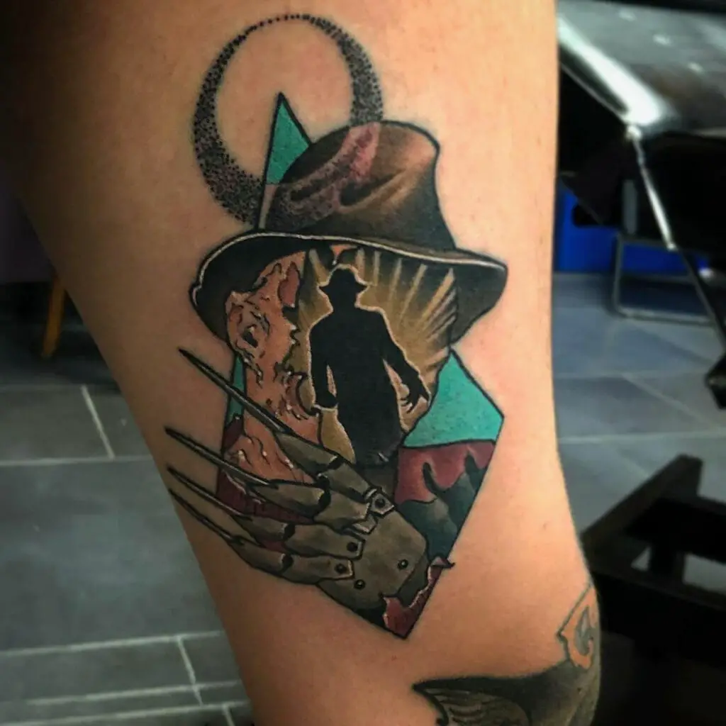 Colored Backdrop Man Wearing a Hat and Claw in Diamond Shape Leg Tattoo
