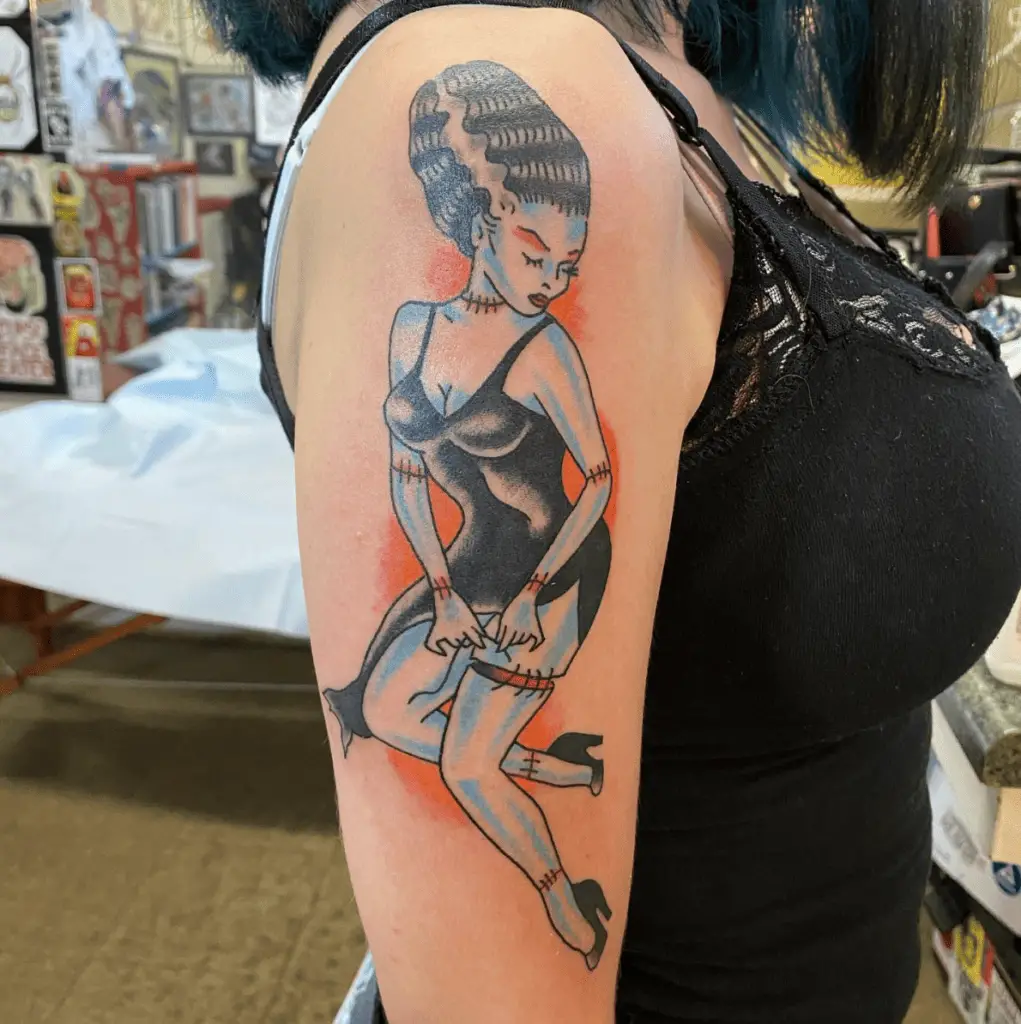 Colored Cartoon Sexy Woman Wearing Black Slit Dress and Heels Upper Arm Tattoo