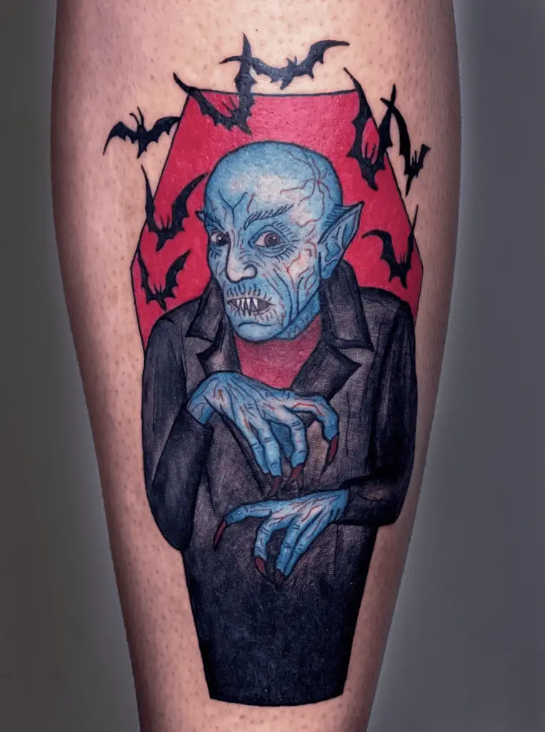 Colored Hairless Vampire in Red Coffin With Bats Arm Tattoo