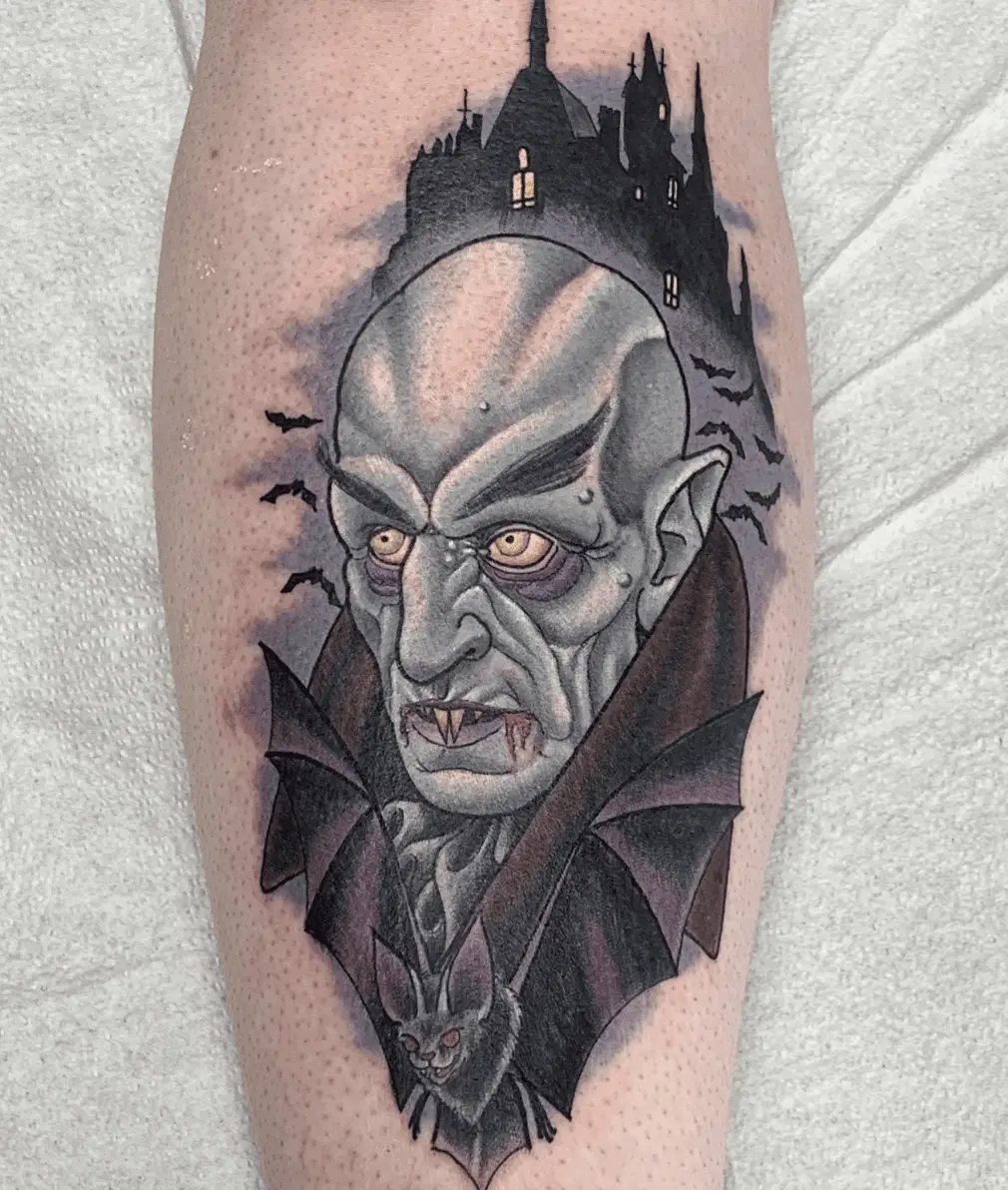 Colored Illustration of Bald Vampire With Bats at the Side and Castle at the Top Arm Tattoo