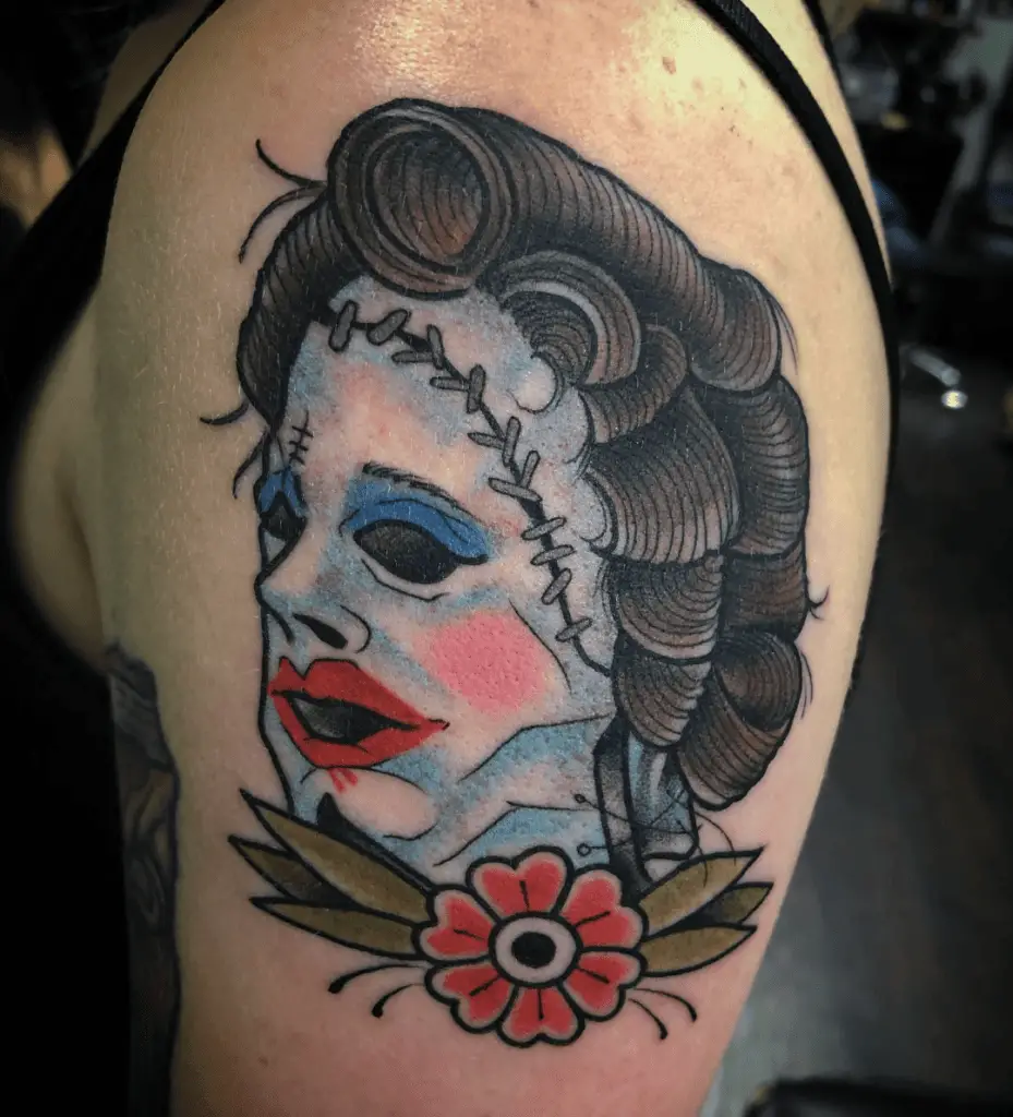 Colored Pretty Lady Human Skin Mask With Stitches Face and a Flower Upper Arm Tattoo