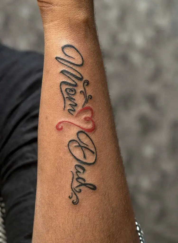 Cursive Mom and Dad With Red Heart Arm Tattoo