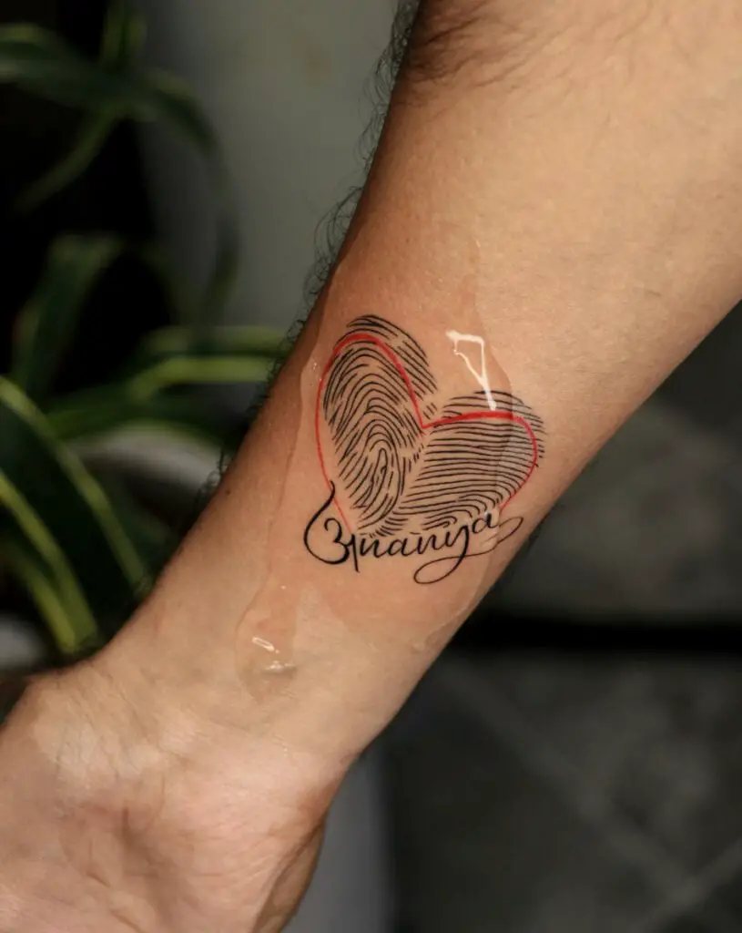 Fingerprint in Heart Shape With Red Line and Text Arm Tattoo