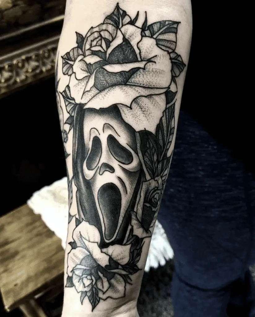 Grim Reaper Screaming Covered With Floral Arm Tattoo