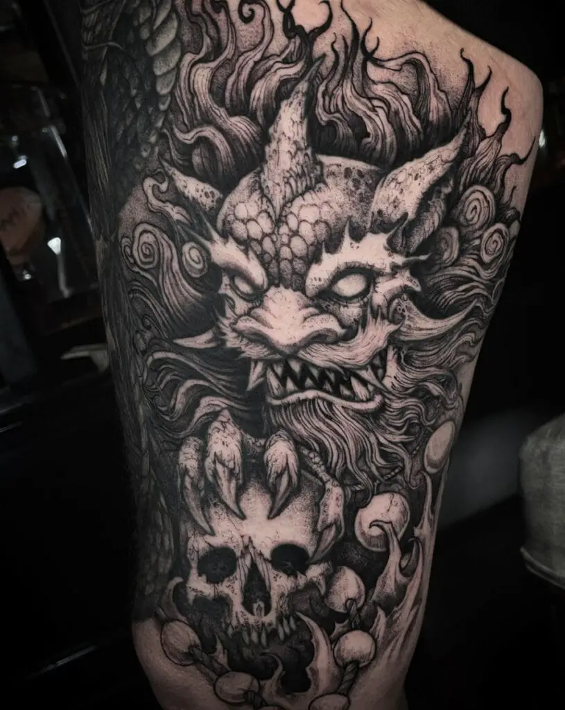 Intimidating Dragon Holding a Skull Head Thigh Tattoo