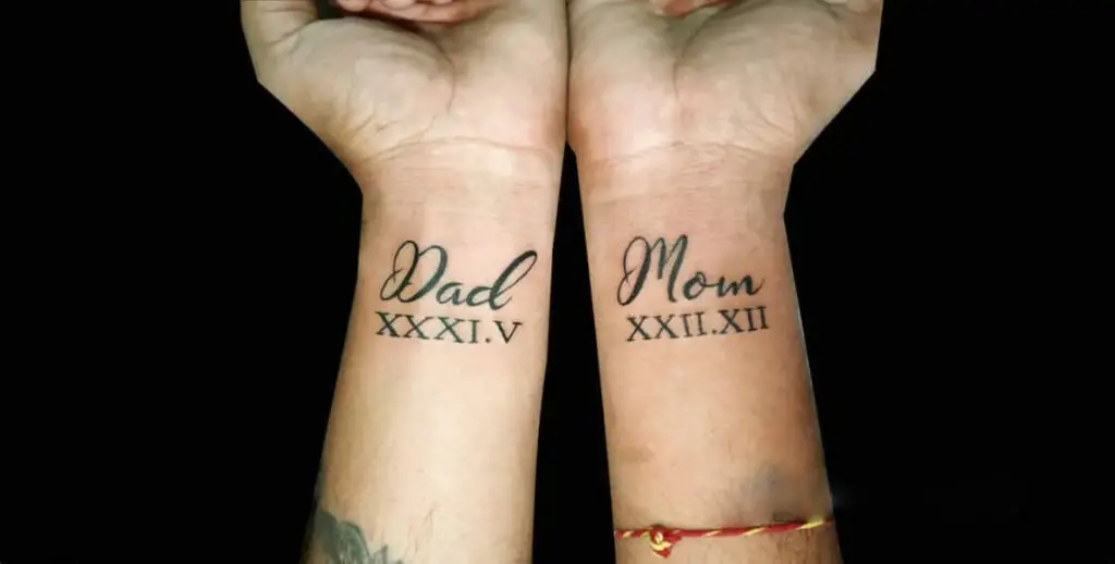 Mom and Dad With Roman Numerals Date Wrist Tattoo