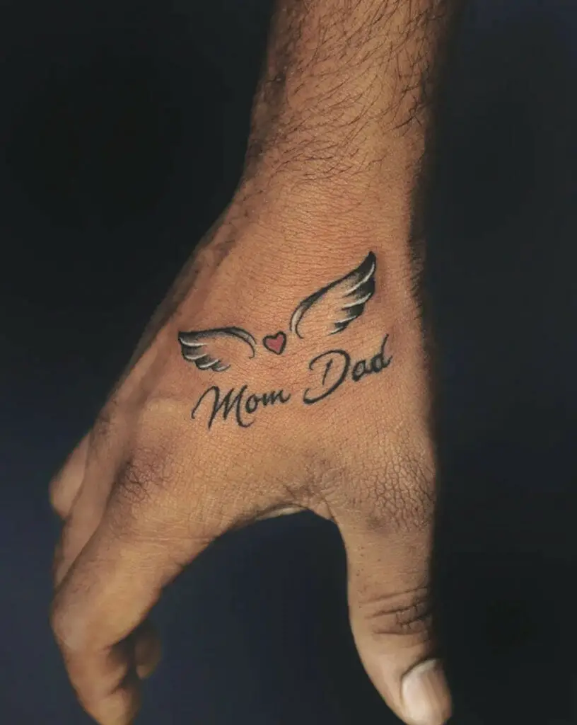 Mom and Dad With Small Heart and Silver Wings Hand Tattoo