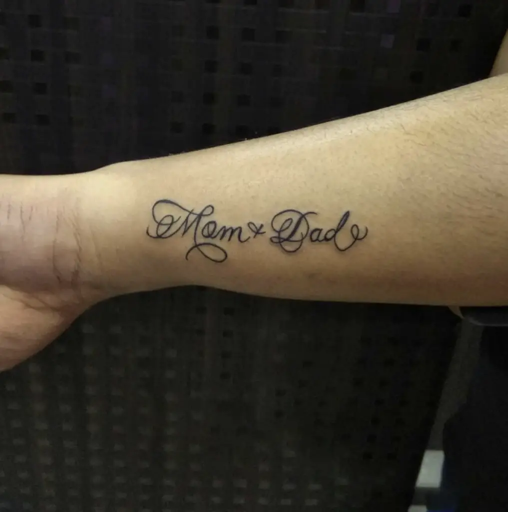 Mom and Dad in Cursive Handwriting Arm Tattoo