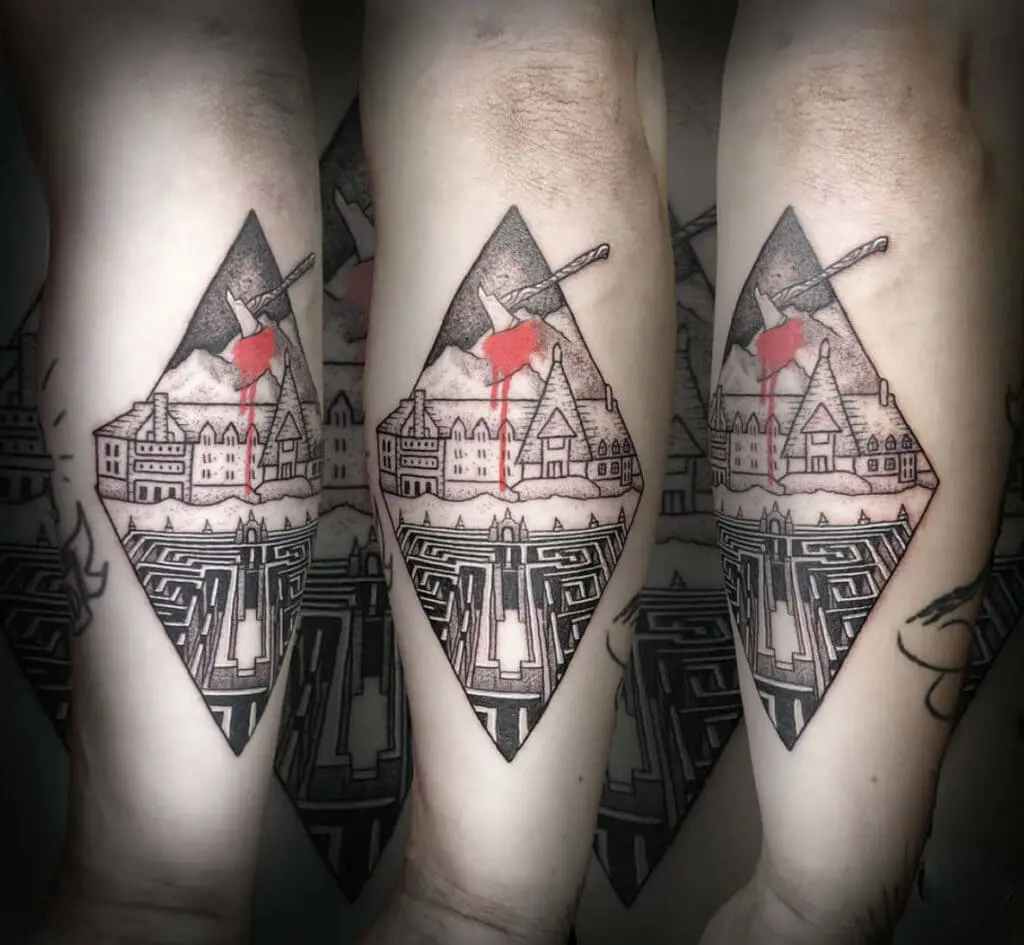 Old Castle With A Mountain Stabbed By Axe Behind And A Mazed Garden In Front Arm Tattoo