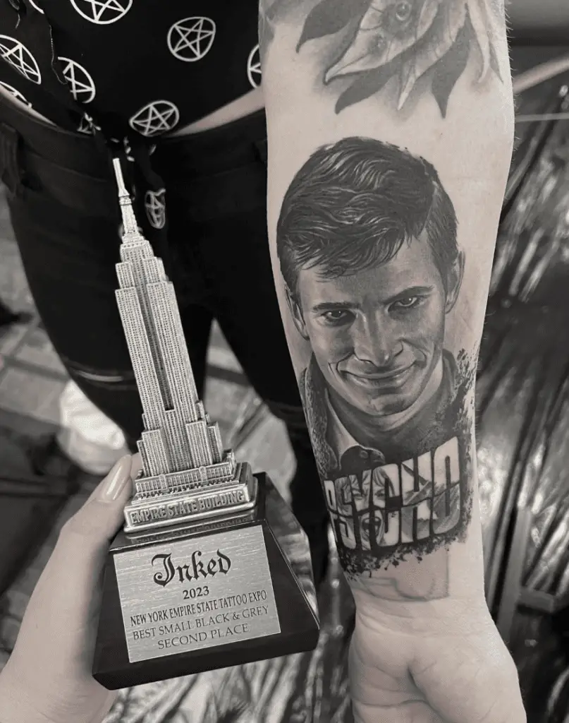 Portrait of a Man Grinning and the Word Psycho Forearm Tattoo