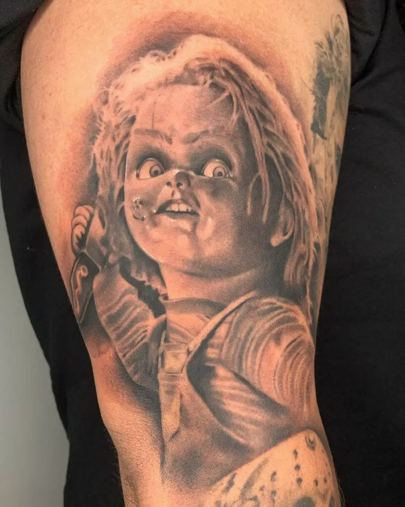 Realistic Chucky Holding a Knife Thigh Tattoo