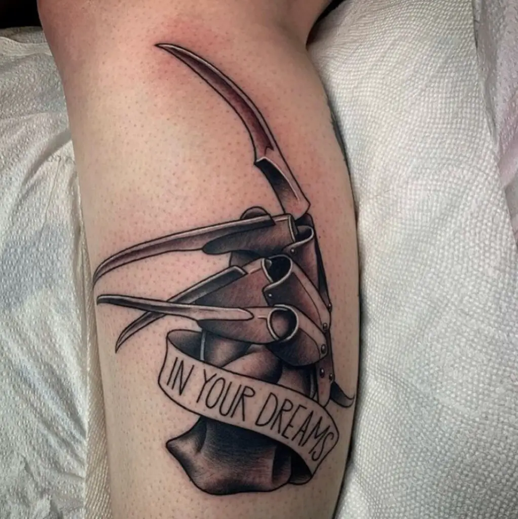 Sharp Claw Glove With Text in Ribbon Leg Tattoo