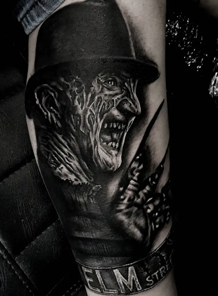 Side Profile of Burned Face Man Laughing Leg Tattoo