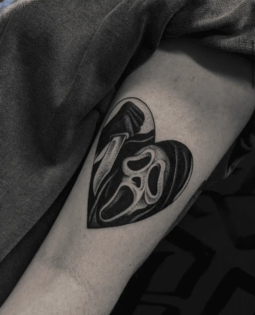 Simple Bold Grim Reaper In A Heart Shape Arm Tattoo