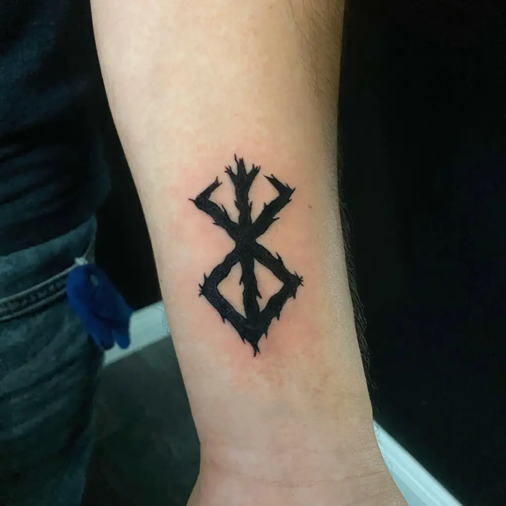 Small Black Tree Branch Berserk Logo Forearm Tattoo