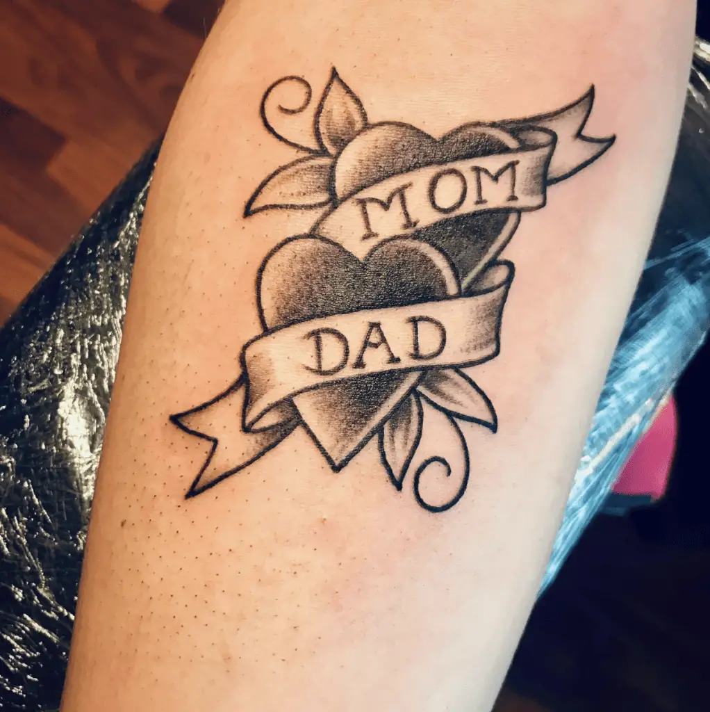 Traditional Mom and Dad With Two Hearts Wrapped in Ribbon Arm Tattoo