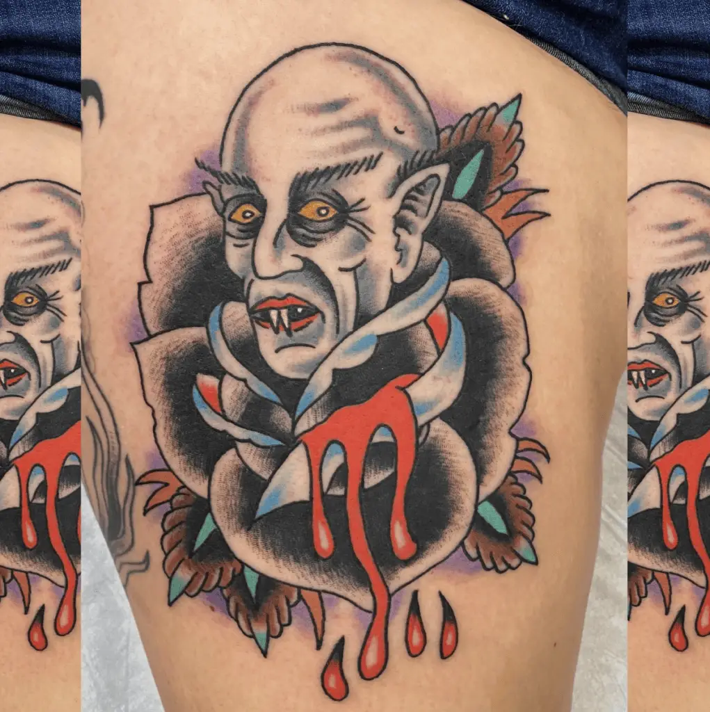 Traditional Style Bald Vsmpire on a Black Rose Dripping Blood Thigh Tattoo