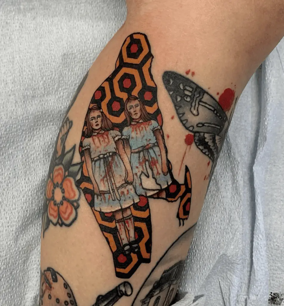 Twins Holding Hands Covered With Blood And Red and Orange Pattern Background Leg Tattoo