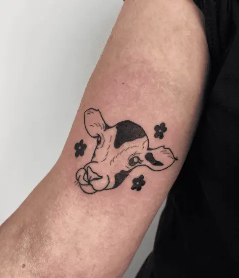 Sticking Tongue Out Cow with Black Flowers Tattoo