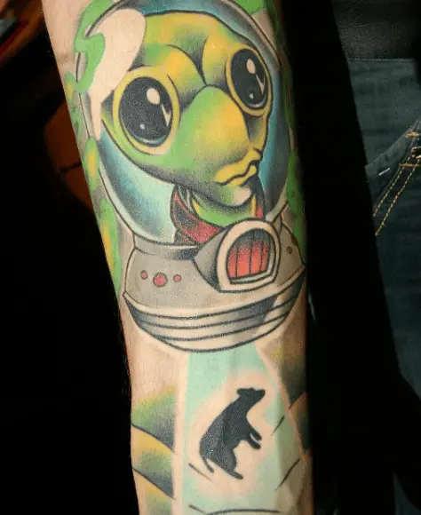 Green Alien with Black Cow Tattoo
