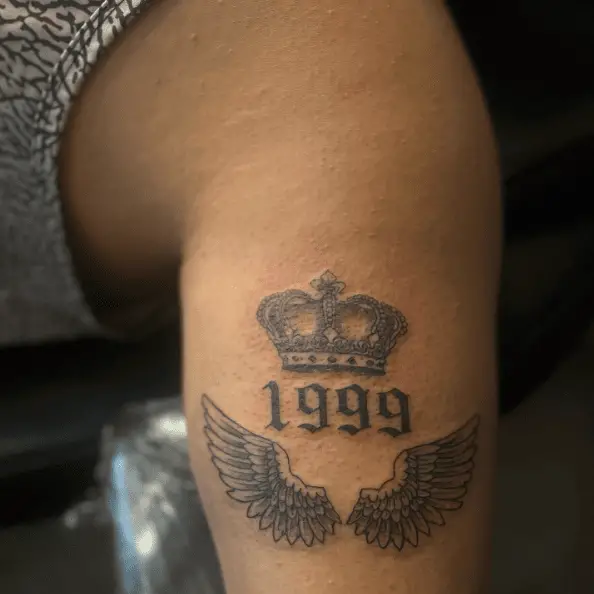 1999 Year with Crown and Angel Wings Tattoo