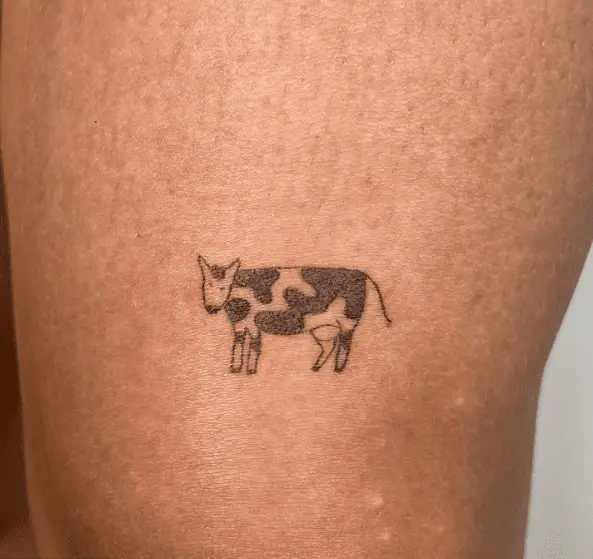 Tiny Black and White Cow Tattoo