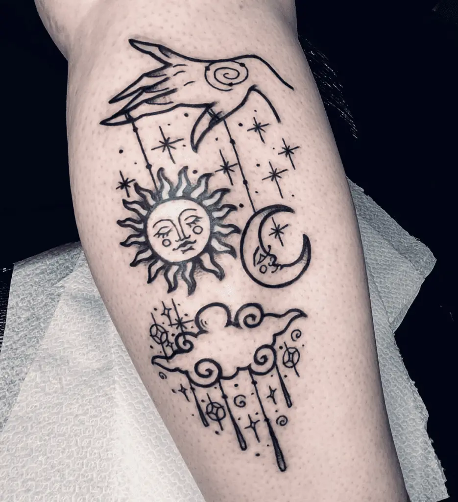 A Hand Attached Sun and Moon to a Strings With Celestial Designs Arm Tattoo