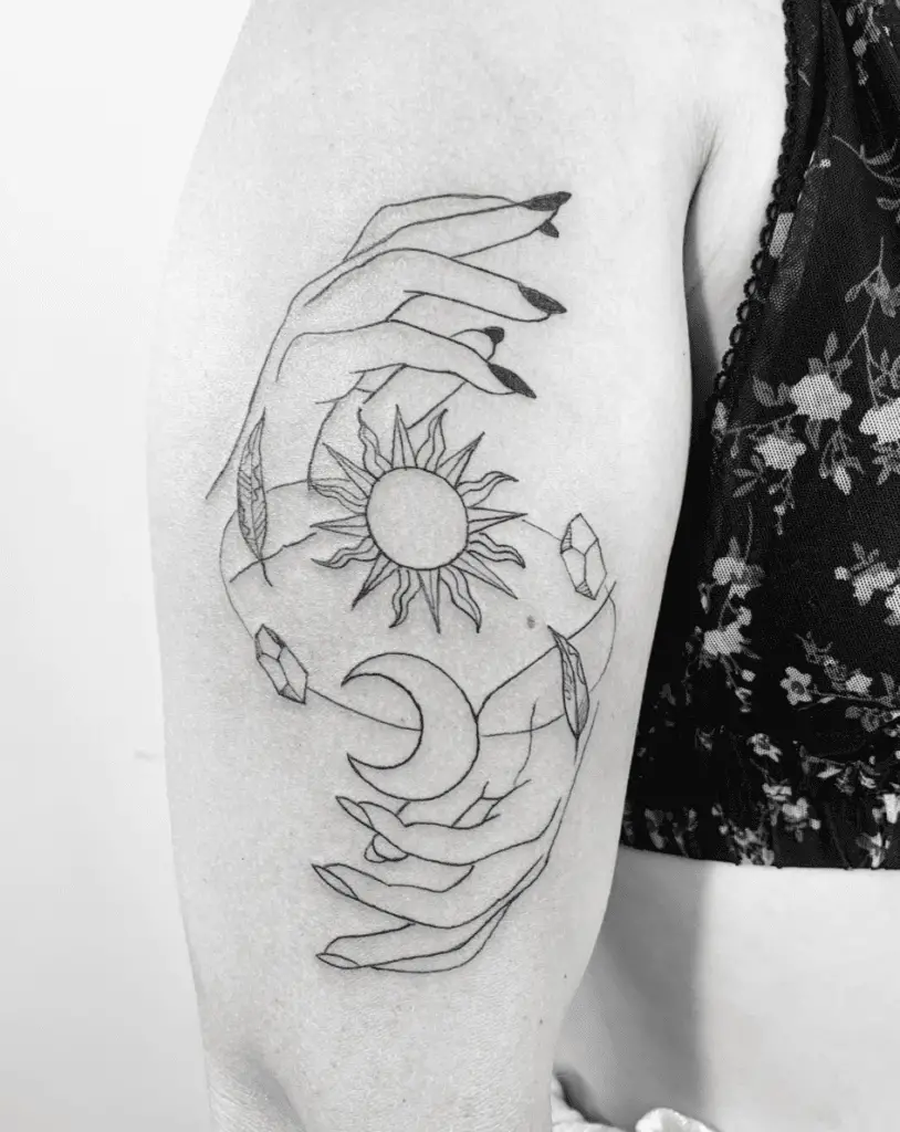 A Hand Grasping Sun and Moon With Gems and Leaves Arm Tattoo