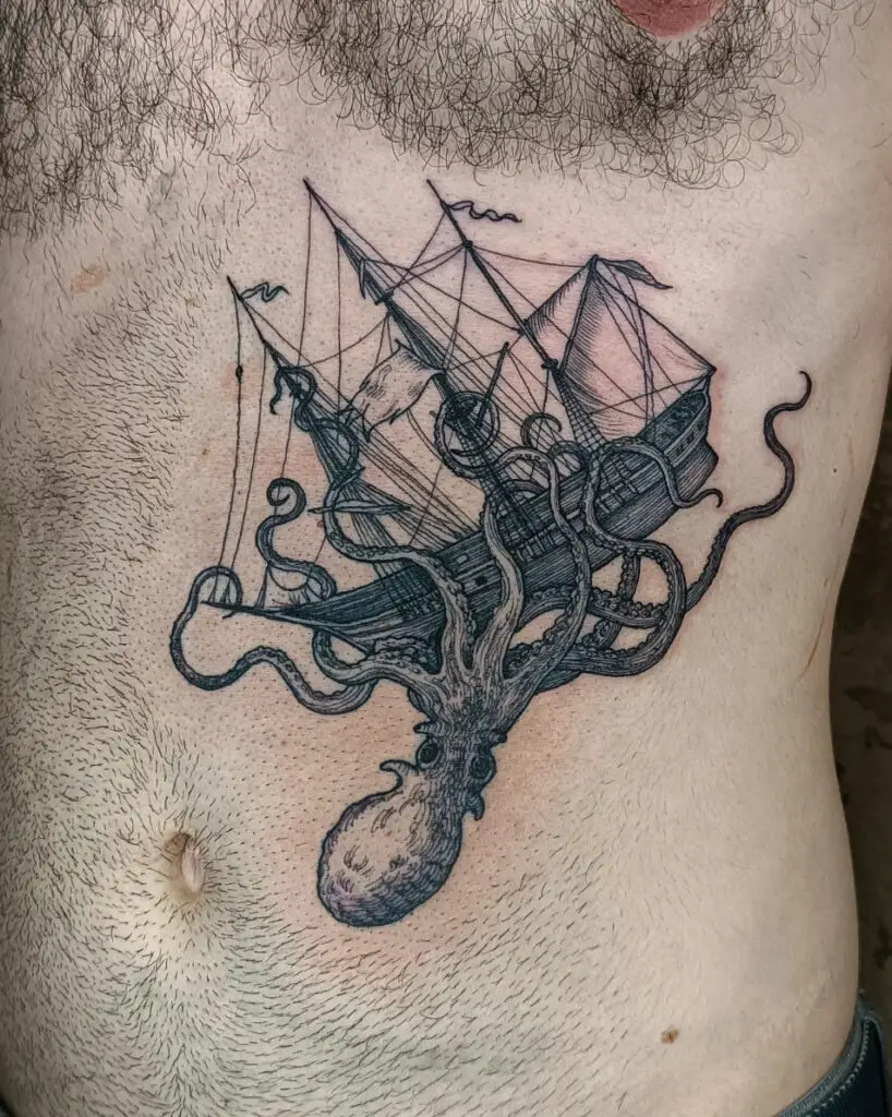 A Kraken Pulling a Pirate Ship Down Stomach Tattoo