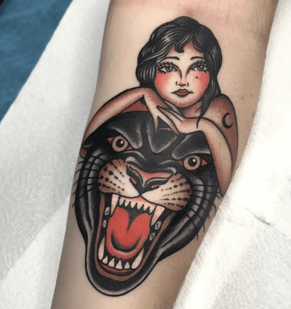 A Pretty Lady Resting at the Top of Black Panther Head Arm Tattoo