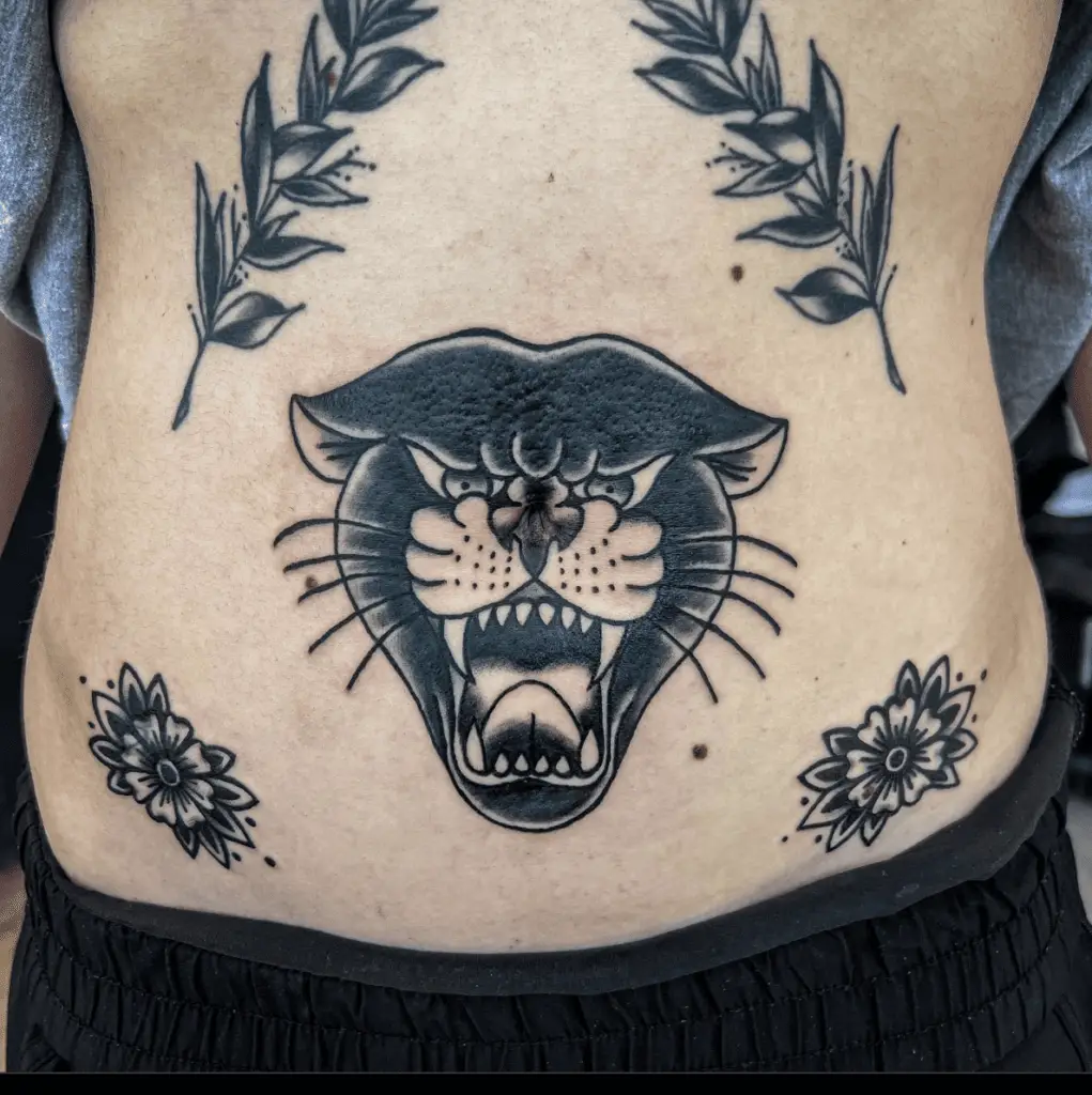Black Angry Panther With Leaves and Flowers Stomach Tattoo