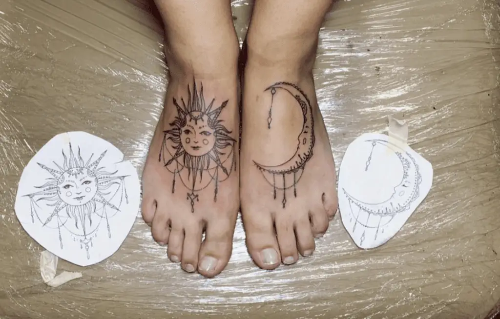 Black Detailed Line Sun and Moon With Hangging Embellishments Feet Tattoo