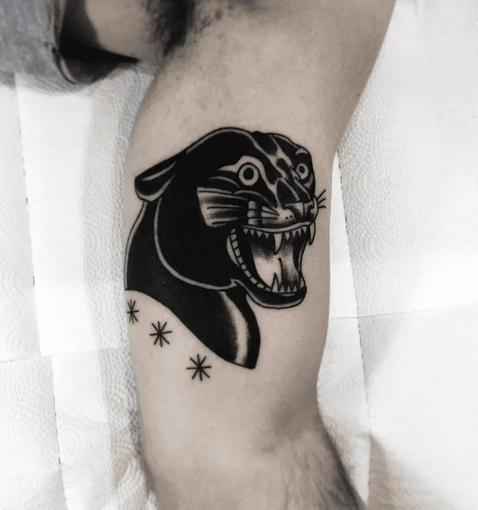 Black Happy Panther Above the Three Stars Upper Arm Tattoo