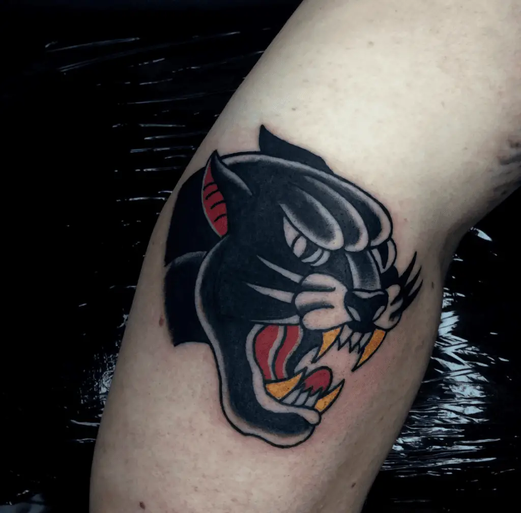 Black Panther Head With Gold Fangs Arm Tattoo