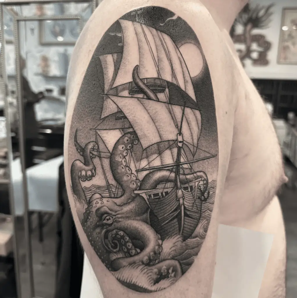 Black and Grey Illustration Kraken Crawling Beside the Ship Upper Arm Tattoo