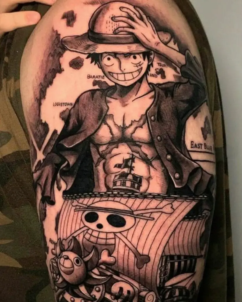 Black and Grey Luffy With Pirate Ship and Map Background Upper Arm Tattoo