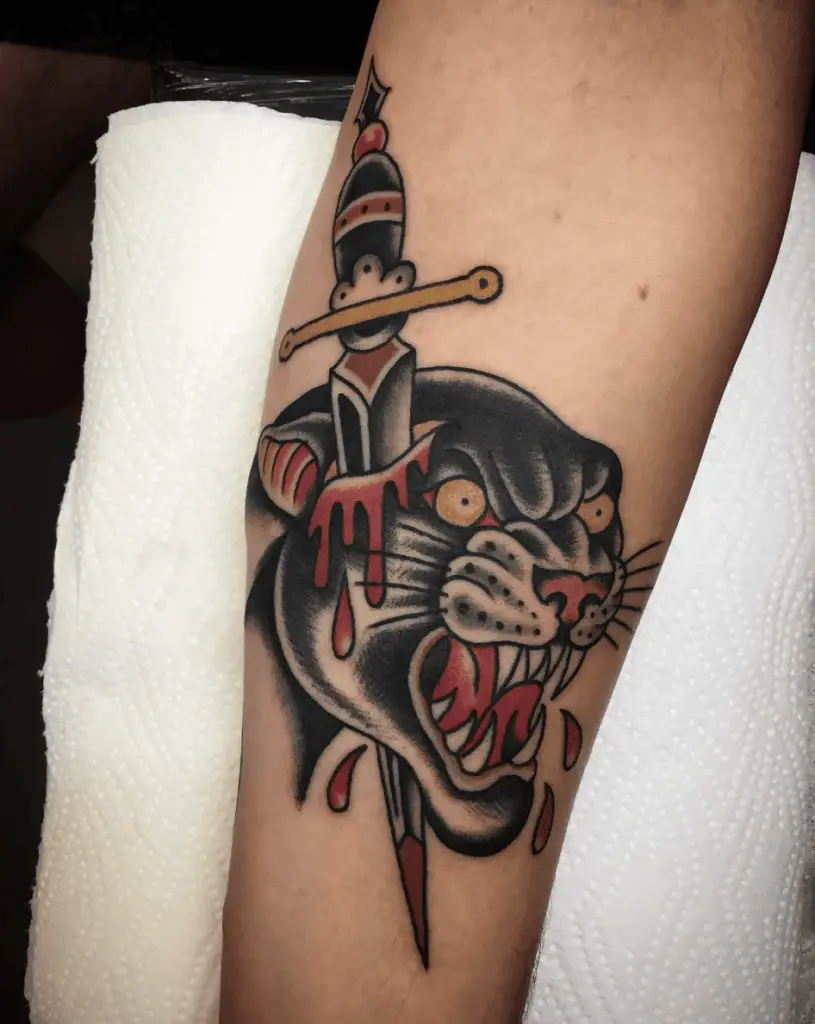 Colored Black Furious Bloody Panther with Dagger Pierced Arm Tattoo