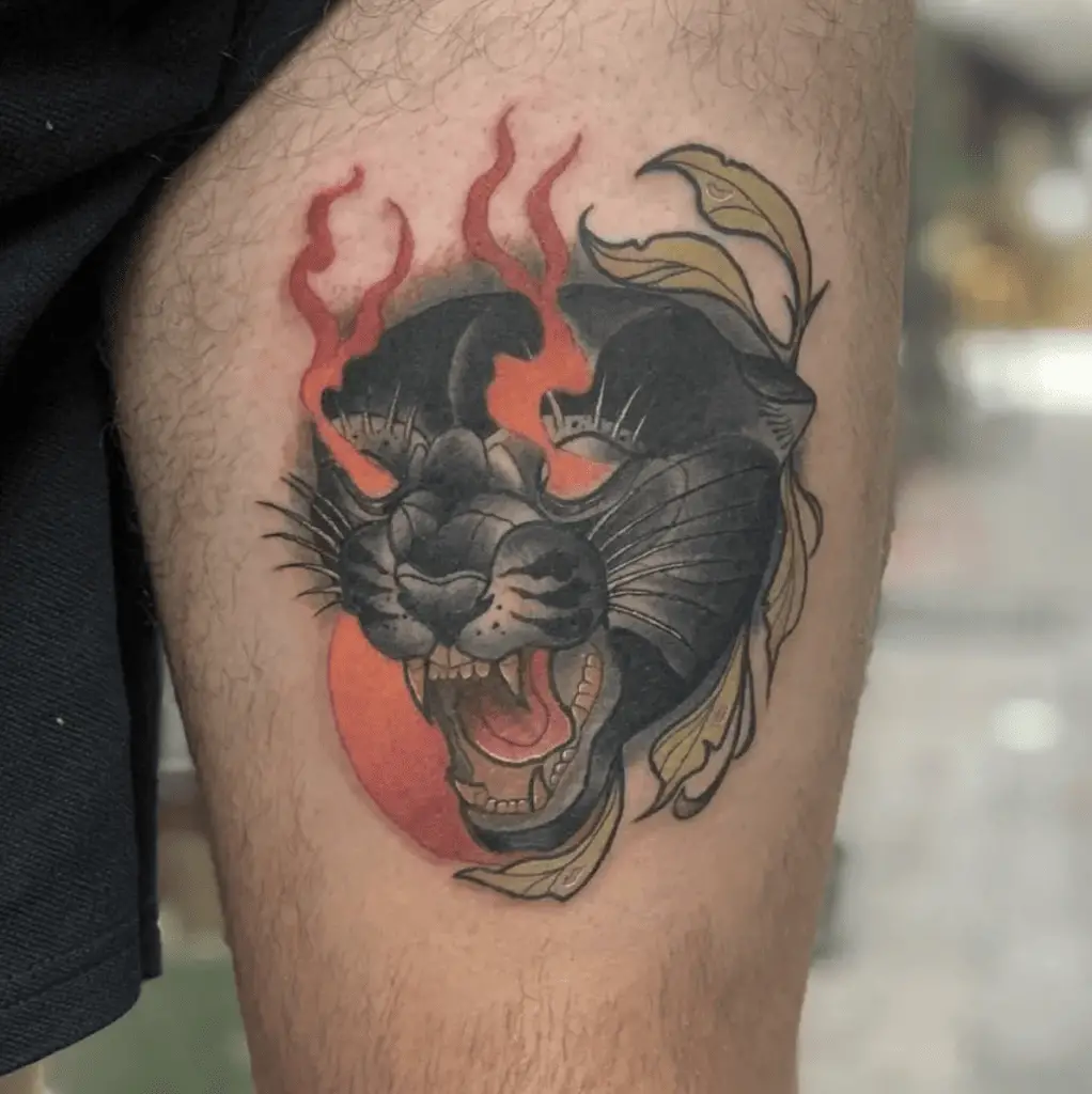 Colored Black Panther Head With Flaming Eyes and Leaves Side Border Thigh Tattoo