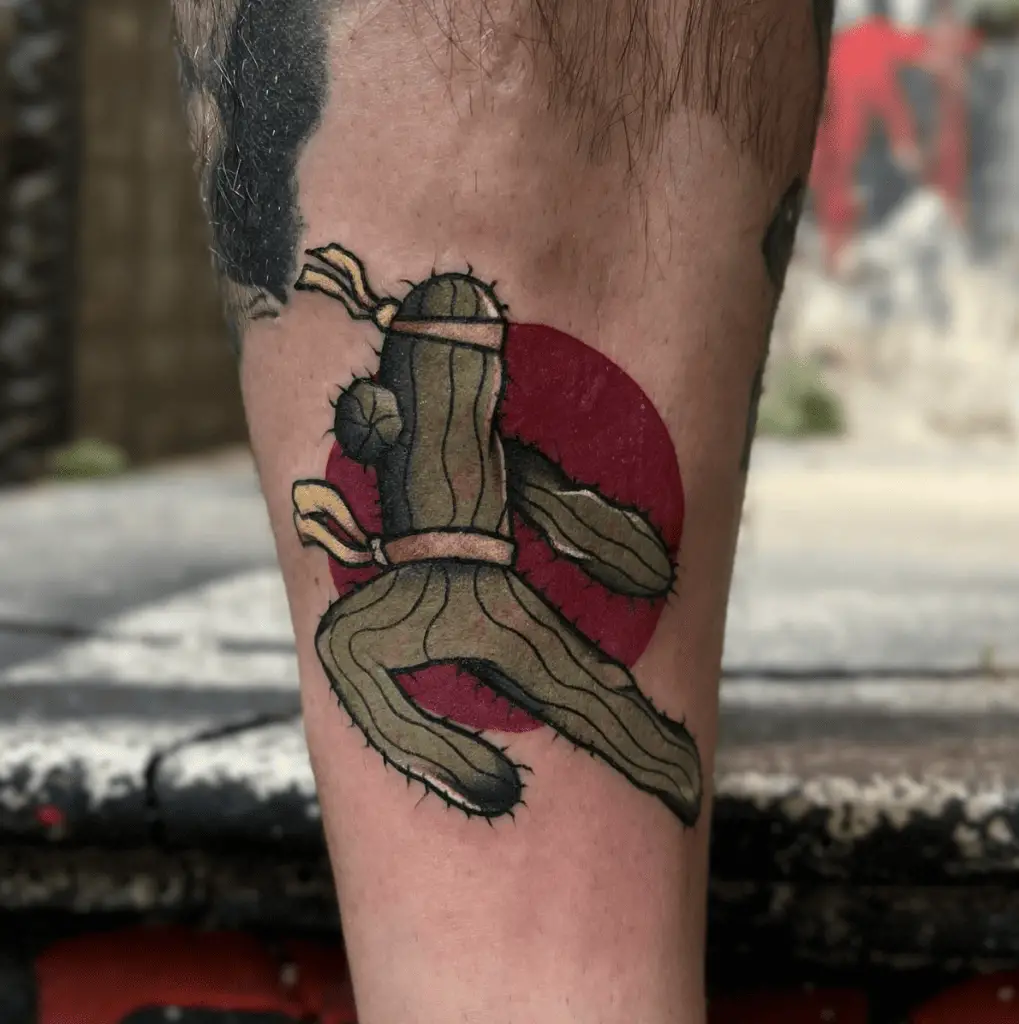 Colored Cactus Doing Karate Pose With Red Circle Background Leg Tattoo