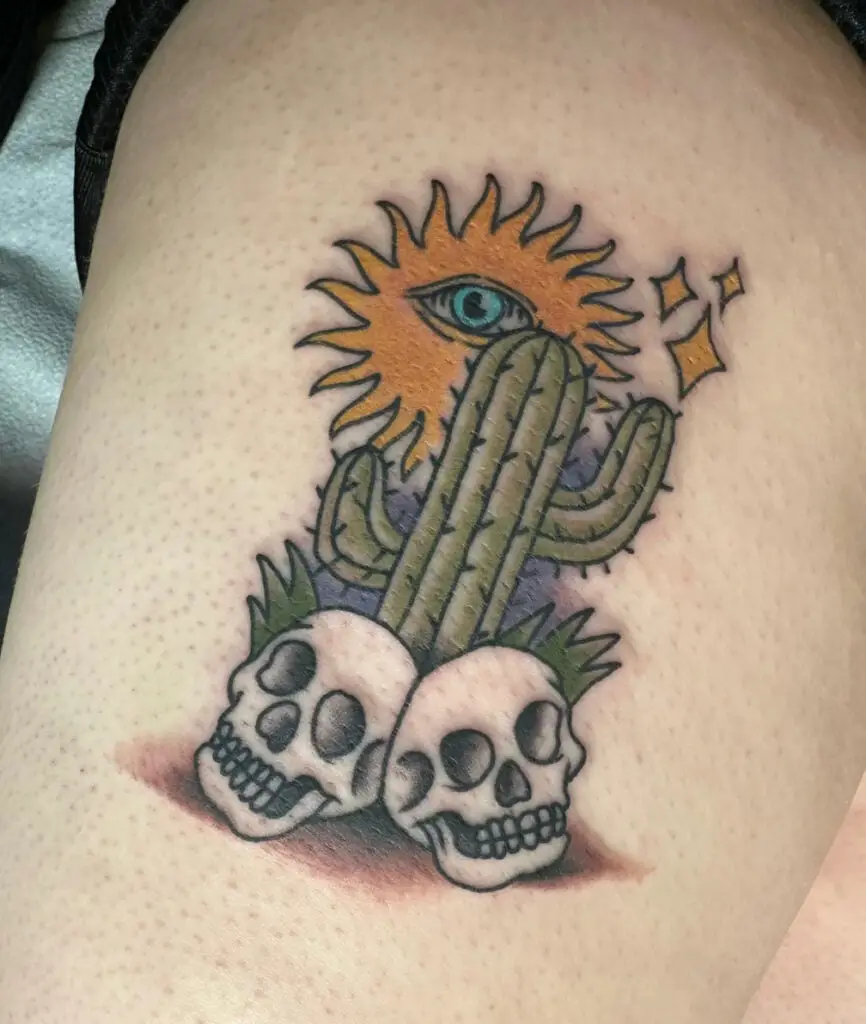 Colored Cactus With Eye Sun and Stars and Two Skulls Thigh Tattoo