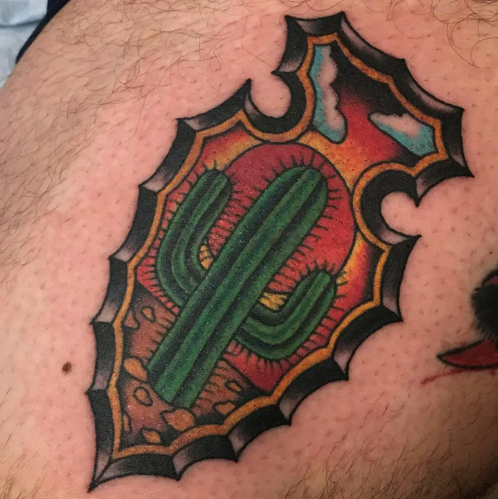 Colored Cactus in a Stoned Arrowhead With Land Background Tattoo