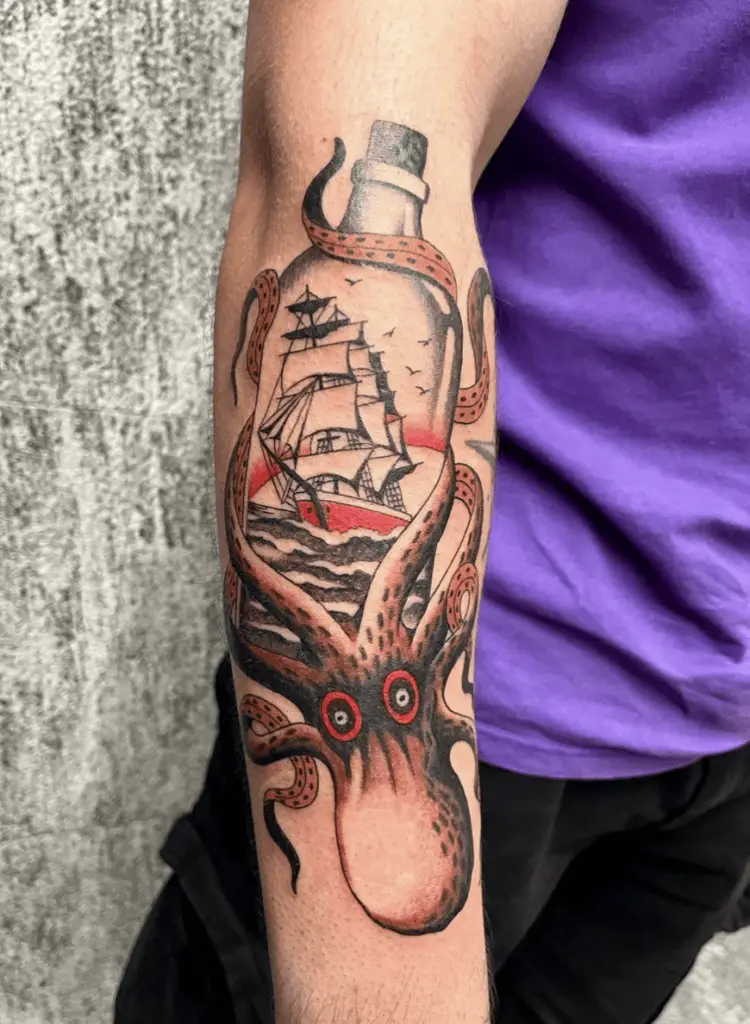 Colored Giant Octopus Holding the Ship in Bottle Arm Tattoo